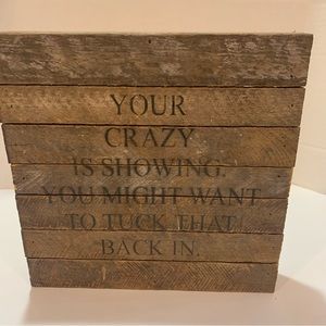 Wooden sign “Your crazy is showing you might want to tuck that back in”